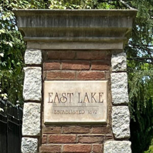 Top portion of stone pillar marking entry to East Lake area. It's sign says: EAST LAKE. Established in 1892.